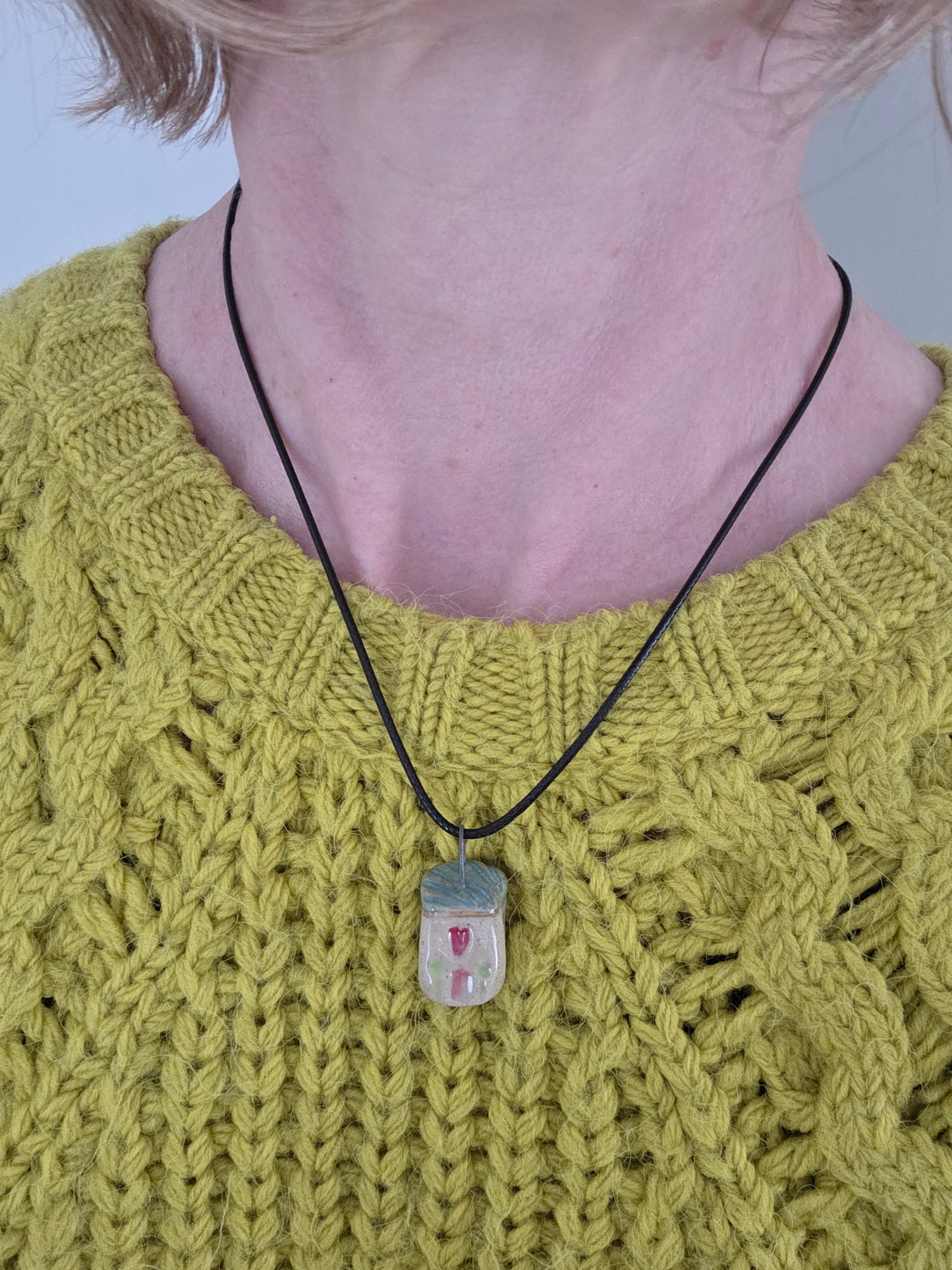 Blue Tiny House Pendant on black waxed cotton necklace