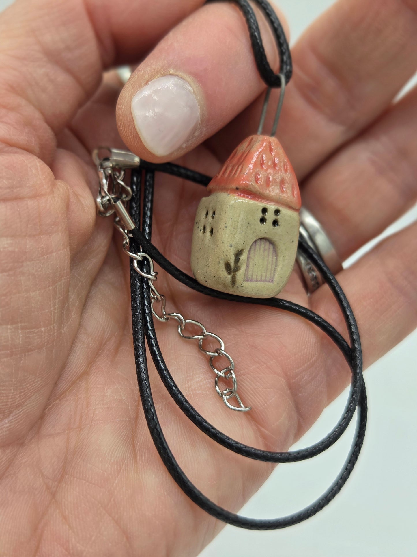 Rose Pink Tiny House Pendant on black waxed cotton necklace