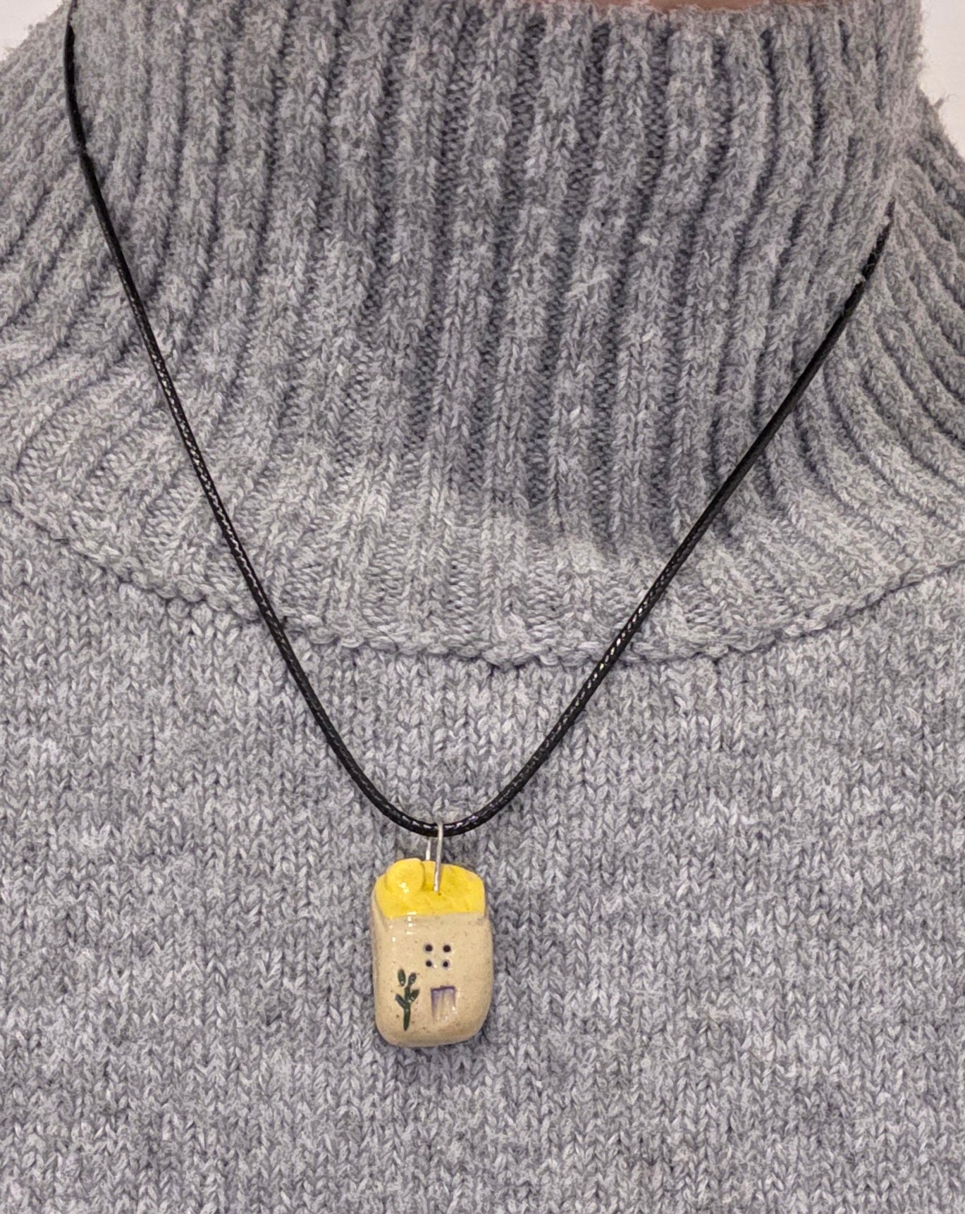Yellow Tiny House Pendant on black waxed cotton necklace