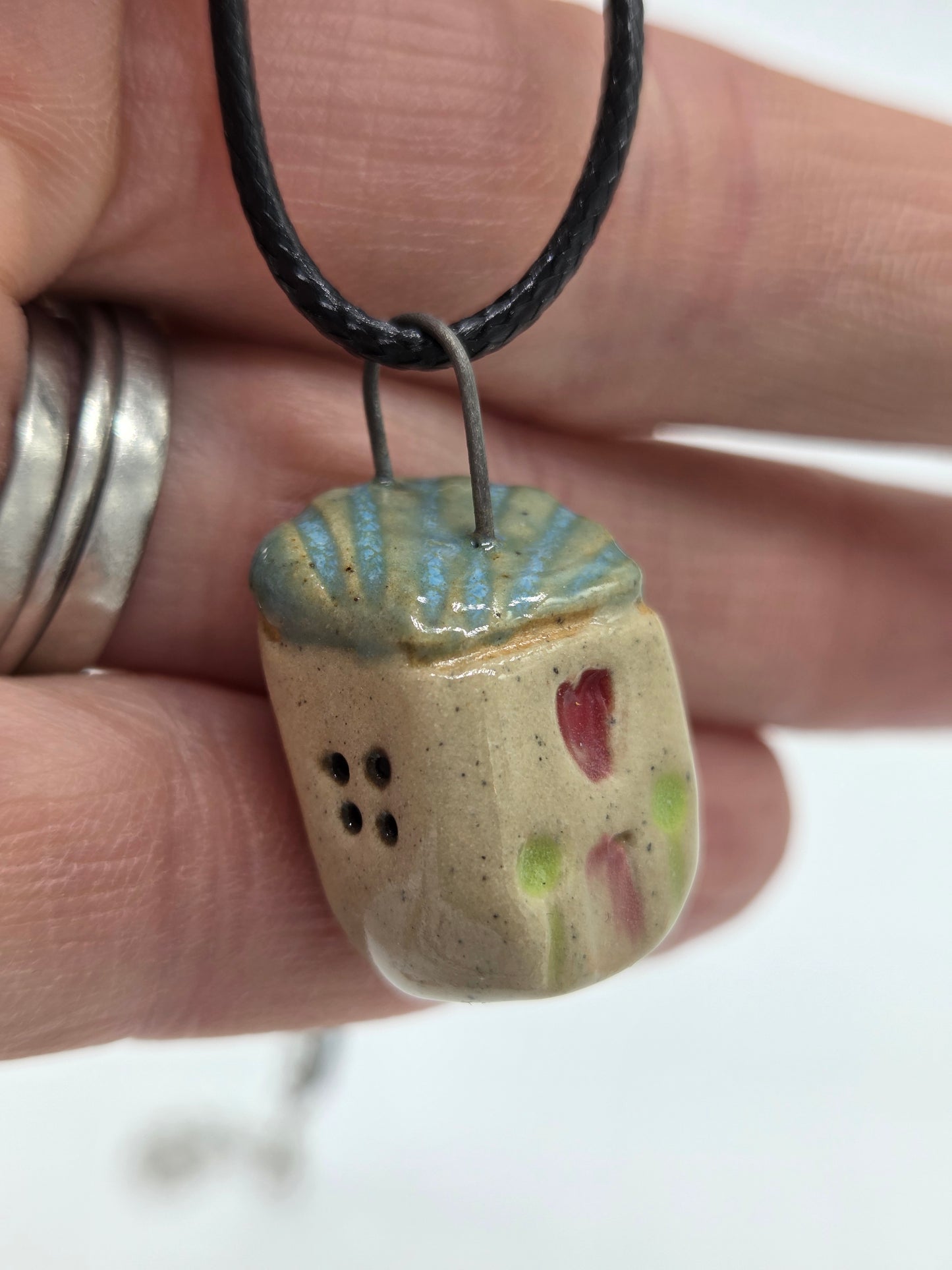 Blue Tiny House Pendant on black waxed cotton necklace