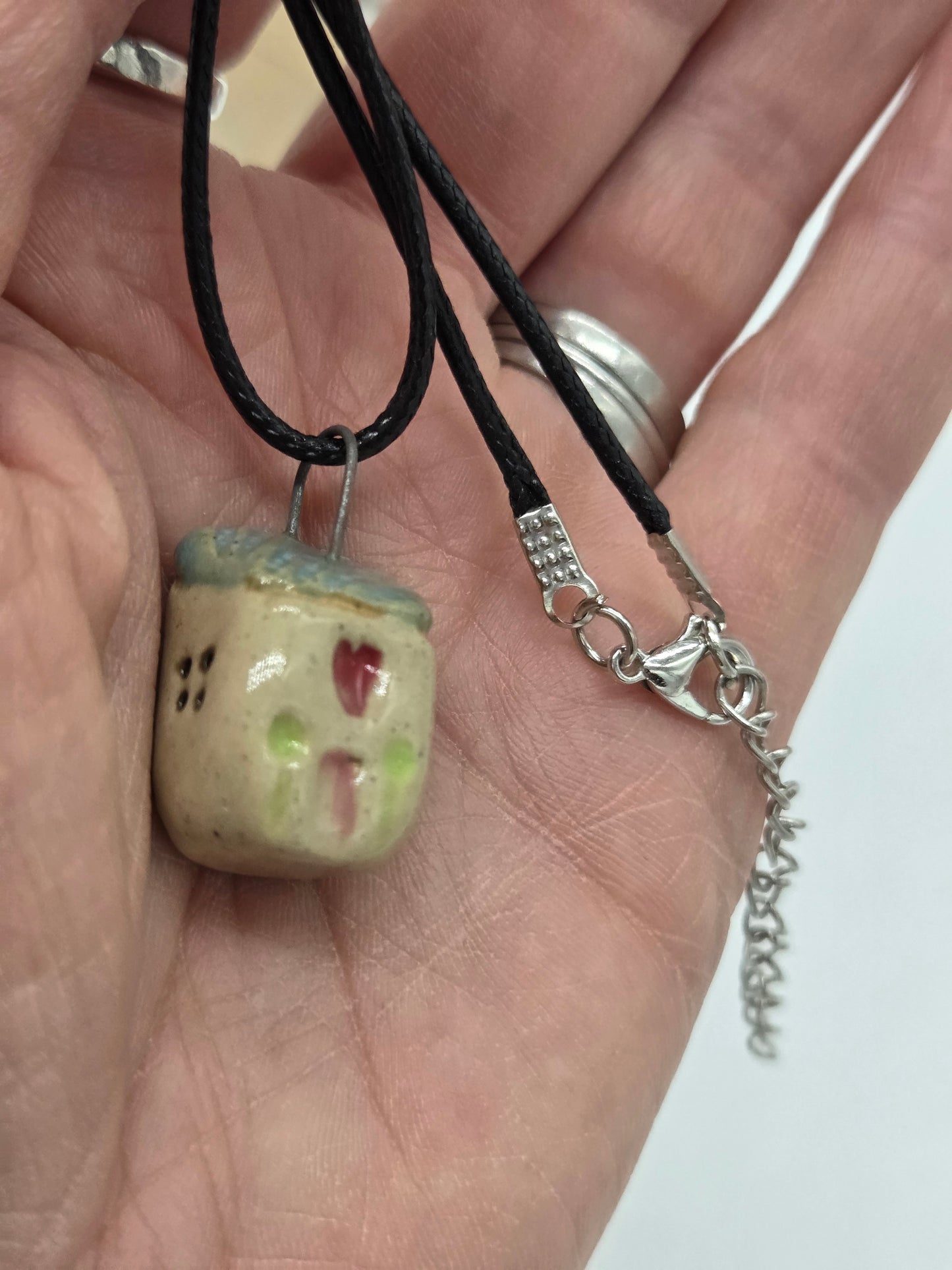 Blue Tiny House Pendant on black waxed cotton necklace
