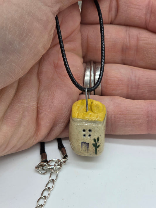 Yellow Tiny House Pendant on black waxed cotton necklace